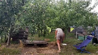 Hot Housewife Lukerya In The Garden With A Rake Cleans In The Pose Of A Dog